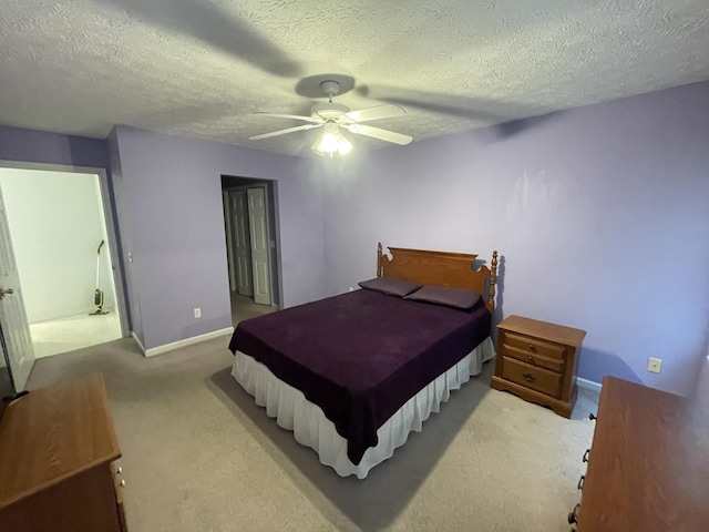 bedroom with carpet, ceiling fan, a textured ceiling, and baseboards