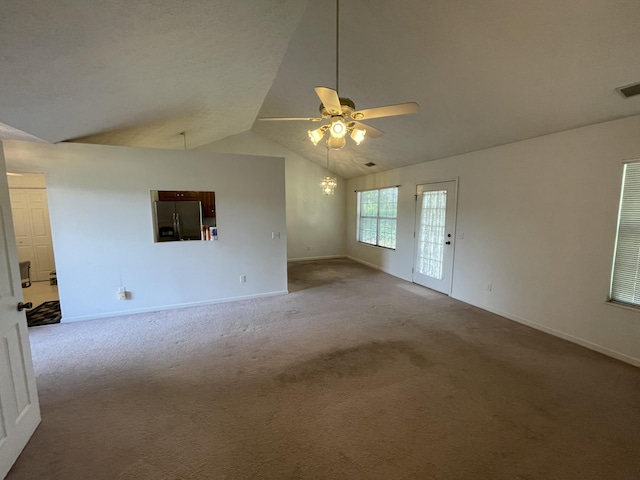 carpeted empty room with ceiling fan, lofted ceiling, and baseboards
