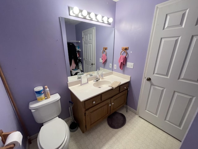 bathroom featuring tile patterned floors, toilet, and vanity