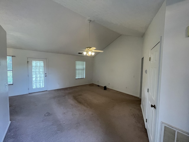 carpeted spare room with plenty of natural light, ceiling fan, lofted ceiling, and baseboards
