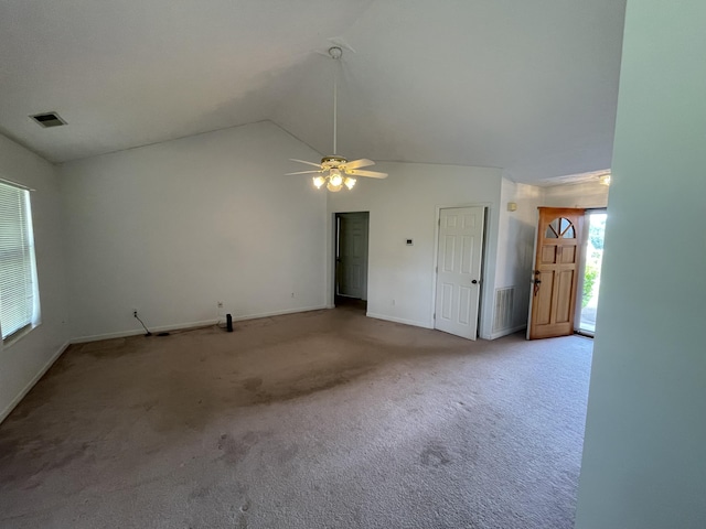unfurnished living room featuring carpet flooring, a ceiling fan, vaulted ceiling, and baseboards