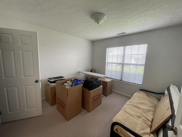 office featuring light carpet and a textured ceiling