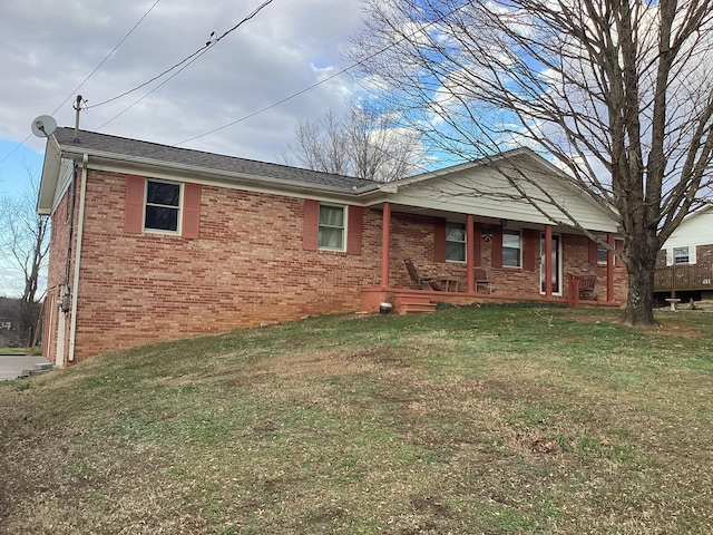 back of property featuring a porch and a yard