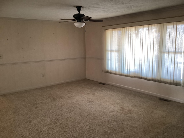 carpeted empty room with a textured ceiling and ceiling fan