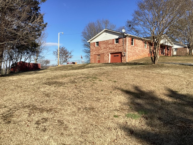 view of property exterior featuring a lawn and a garage