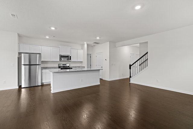 305 Eclipse Ln, Knoxville, TN 37924 - kitchen featuring stainless steel appliances, a center island with sink, dark wood-type flooring, white cabinetry, and recessed lighting
