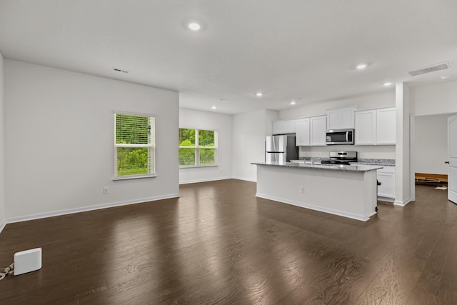 305 Eclipse Ln, Knoxville, TN 37924 - kitchen featuring appliances with stainless steel finishes, recessed lighting, a center island with sink, dark wood finished floors, and white cabinets