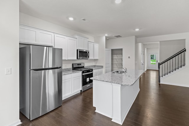 305 Eclipse Ln, Knoxville, TN 37924 - kitchen with stainless steel appliances, dark wood-style floors, white cabinets, a center island with sink, and recessed lighting