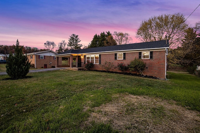 ranch-style house featuring a lawn