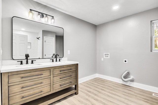 bathroom with vanity, hardwood / wood-style flooring, and a shower