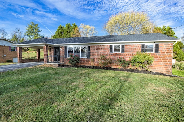 single story home featuring a front lawn and a carport