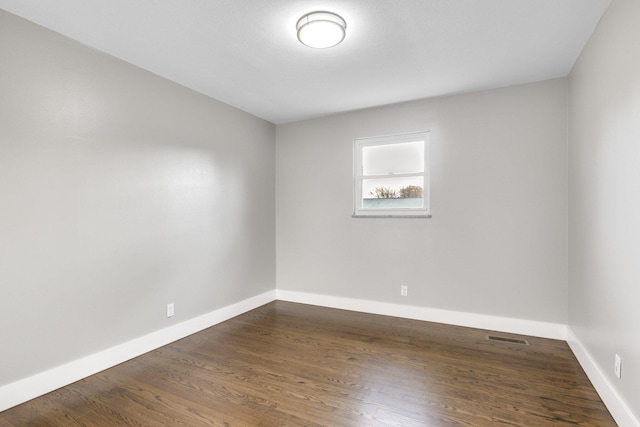 empty room featuring dark wood-type flooring