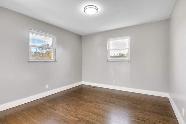 unfurnished room featuring dark hardwood / wood-style floors