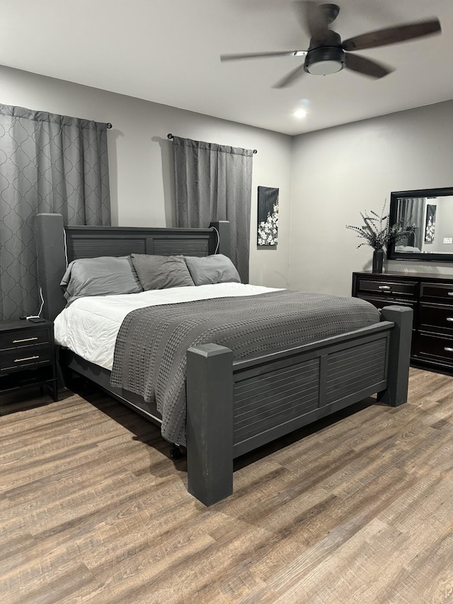 bedroom with ceiling fan and wood finished floors