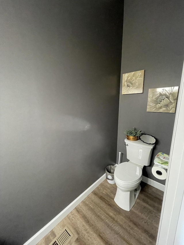 bathroom featuring hardwood / wood-style floors and toilet