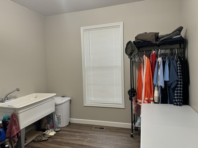 clothes washing area featuring hardwood / wood-style floors