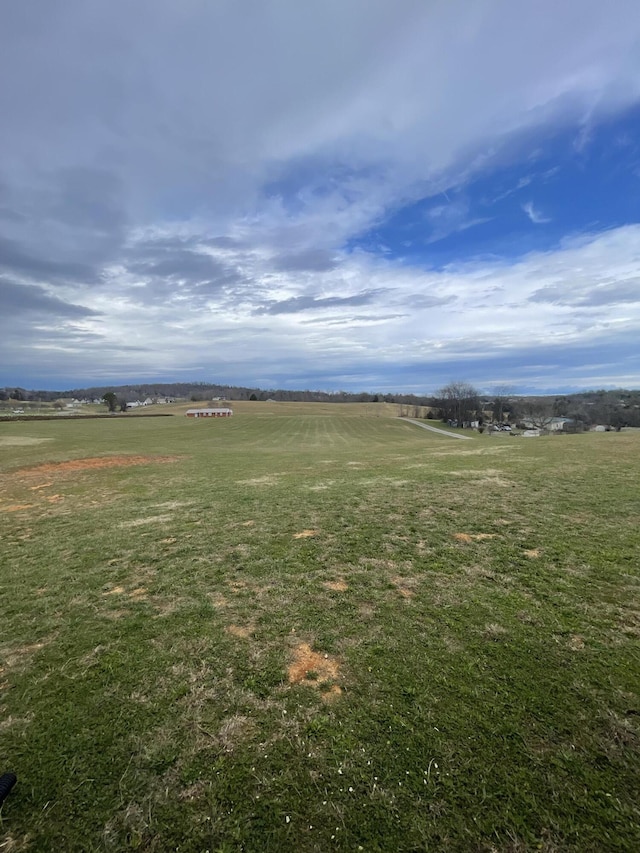 view of yard with a rural view