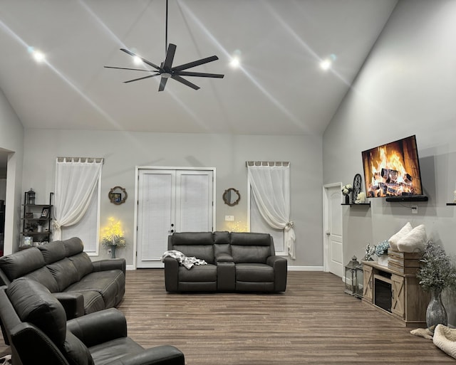 living room featuring hardwood / wood-style flooring, high vaulted ceiling, and ceiling fan