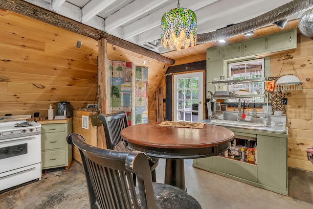 kitchen with sink, white stove, wooden walls, and green cabinetry