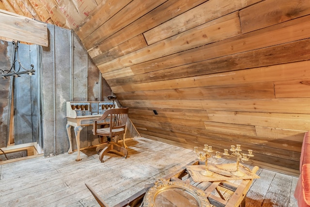 interior space featuring wood-type flooring, wood ceiling, wooden walls, and vaulted ceiling