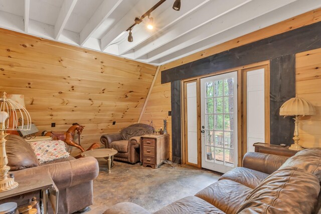 living room featuring wooden walls and concrete floors