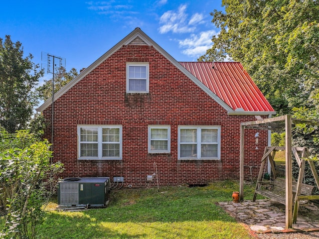 3004 Vine St, White Pine, TN 37890 - view of side of property with brick siding, a metal roof, a lawn, and a patio