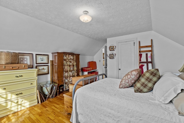 3004 Vine St, White Pine, TN 37890 - bedroom featuring light wood-style floors, vaulted ceiling, and a textured ceiling