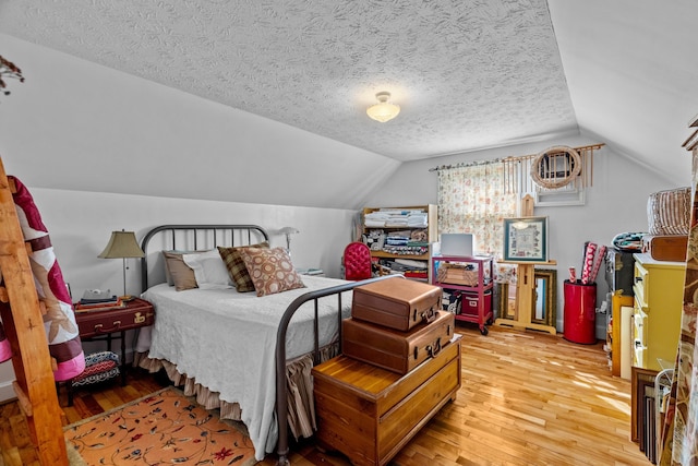 3004 Vine St, White Pine, TN 37890 - bedroom with light wood finished floors, lofted ceiling, and a textured ceiling