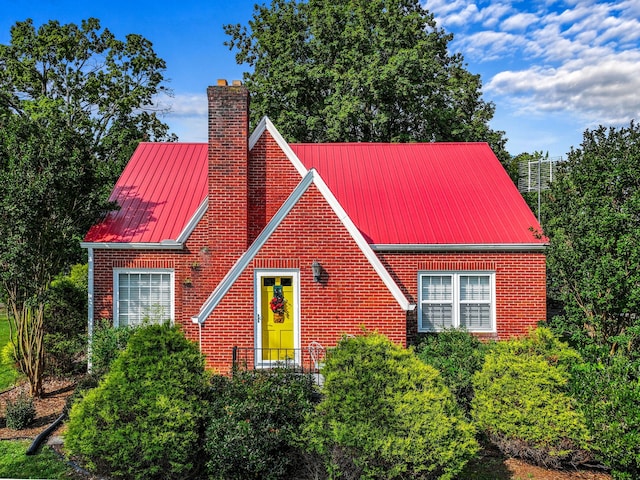 3004 Vine St, White Pine, TN 37890 - view of front of house featuring a metal roof, brick siding, a chimney, and a standing seam roof
