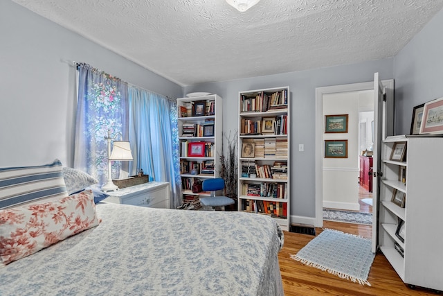 3004 Vine St, White Pine, TN 37890 - bedroom with wood finished floors and a textured ceiling