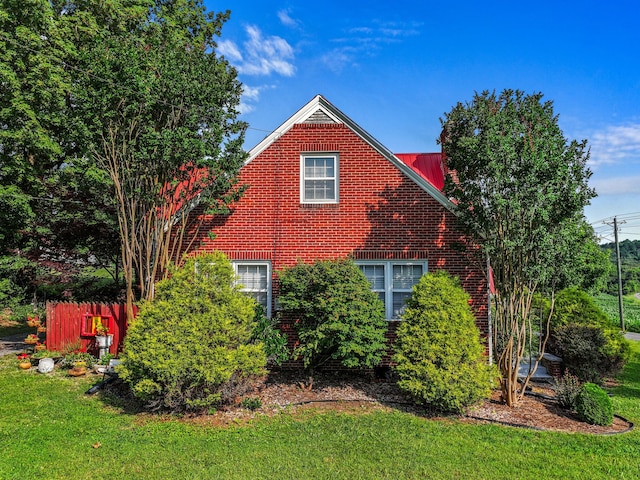 3004 Vine St, White Pine, TN 37890 - view of side of home featuring a yard, brick siding, and a metal roof