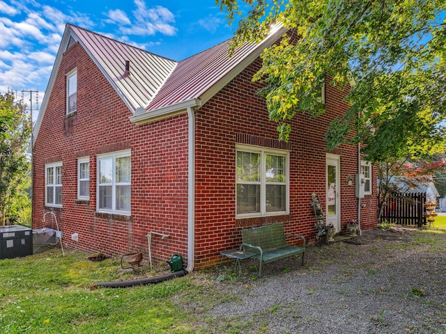 3004 Vine St, White Pine, TN 37890 - view of property exterior featuring brick siding, a standing seam roof, and a metal roof