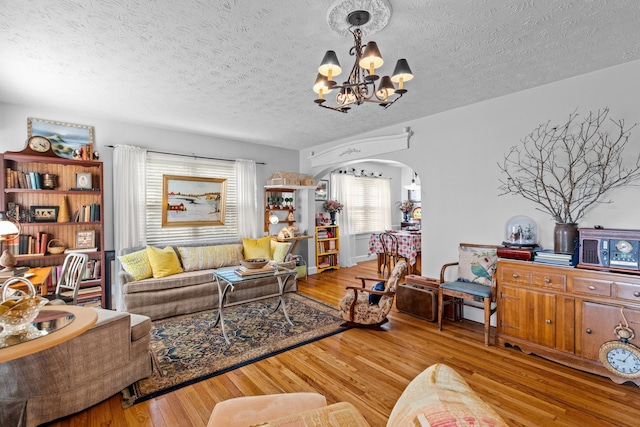 3004 Vine St, White Pine, TN 37890 - living area with a chandelier, arched walkways, wood finished floors, and a textured ceiling