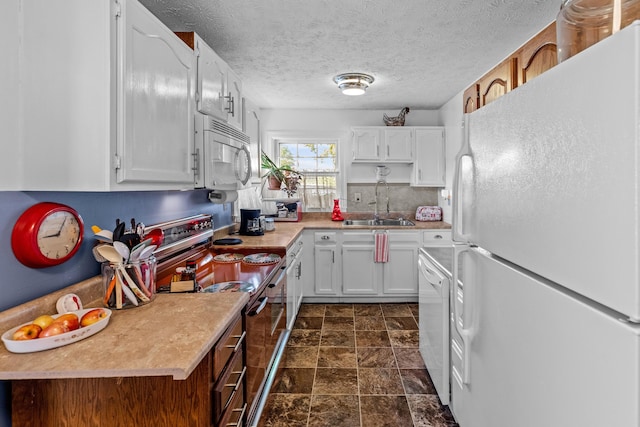 3004 Vine St, White Pine, TN 37890 - kitchen featuring white appliances, white cabinets, light countertops, dark stone finish flooring, and a textured ceiling