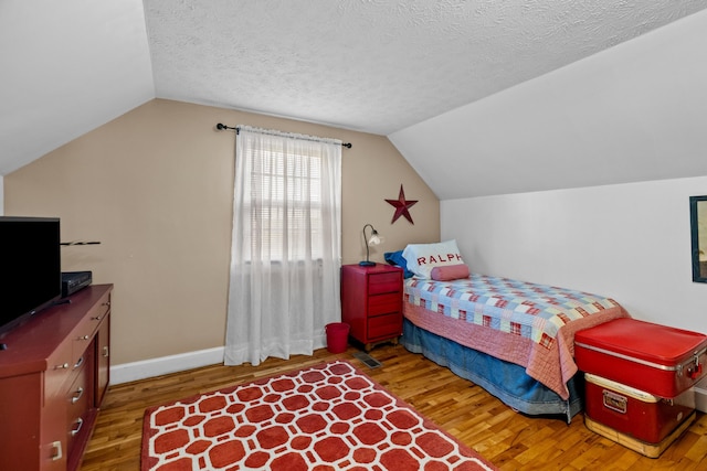 3004 Vine St, White Pine, TN 37890 - bedroom with wood finished floors, vaulted ceiling, and a textured ceiling