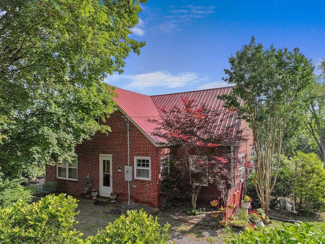 3004 Vine St, White Pine, TN 37890 - view of front of house with brick siding and a metal roof