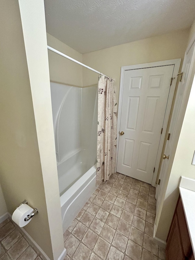 1623 Monte Vista Dr, Sevierville, TN 37862 - full bath featuring vanity, shower / bathtub combination with curtain, baseboards, and a textured ceiling