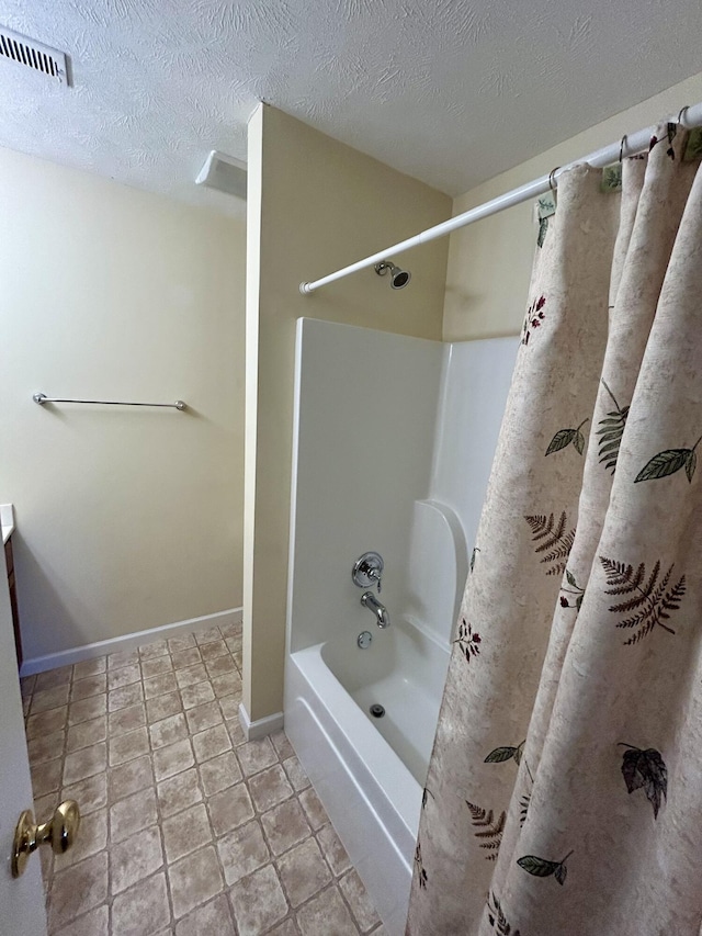 1623 Monte Vista Dr, Sevierville, TN 37862 - bathroom with shower / bath combo with shower curtain, baseboards, and a textured ceiling