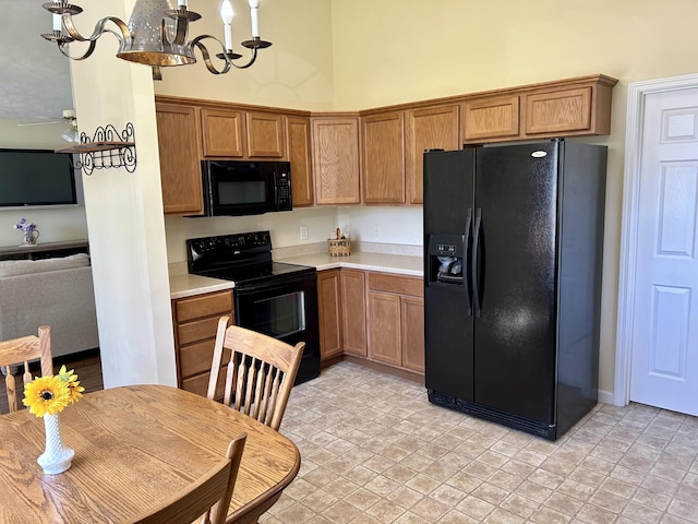 1623 Monte Vista Dr, Sevierville, TN 37862 - kitchen featuring black appliances, light countertops, a chandelier, and brown cabinets