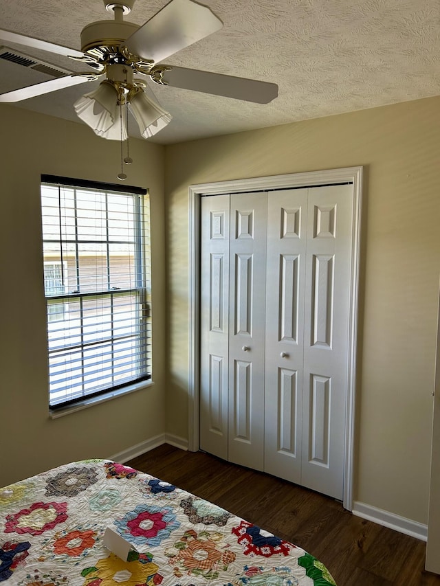 1623 Monte Vista Dr, Sevierville, TN 37862 - bedroom with dark wood-style flooring, baseboards, ceiling fan, a closet, and a textured ceiling