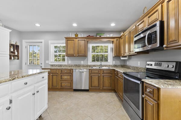 1211 W 6th N St, Morristown, TN 37814 - kitchen featuring appliances with stainless steel finishes, brown cabinetry, light stone countertops, white cabinetry, and recessed lighting