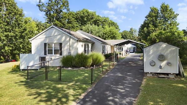 1211 W 6th N St, Morristown, TN 37814 - view of front of house with a carport, driveway, a gate, and a storage unit