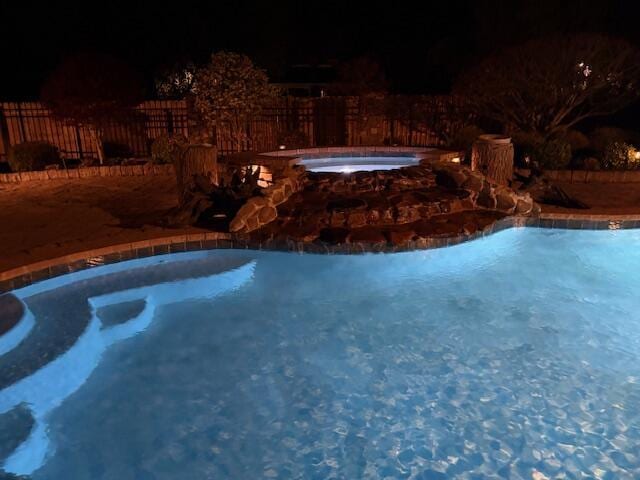 2657 Lakemoore Dr, Morristown, TN 37814 - pool at night featuring an in-ground hot tub and fence