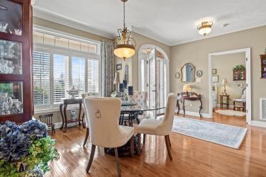 dining room with ornamental molding, wood finished floors, visible vents, and baseboards