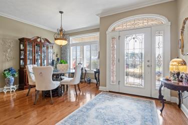 dining area with crown molding, baseboards, and wood finished floors