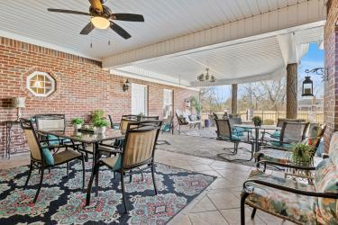 view of patio with outdoor dining space and a ceiling fan