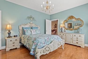 bedroom featuring baseboards, a chandelier, and wood finished floors