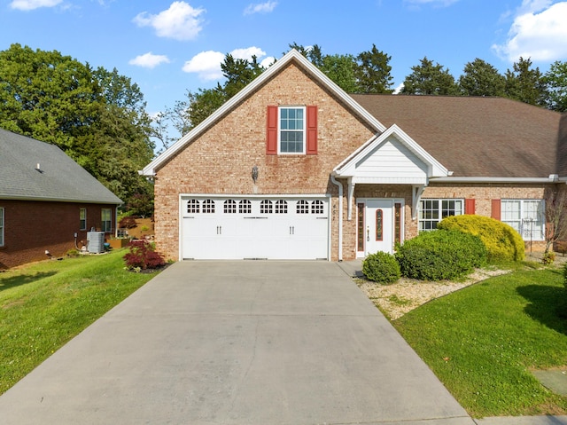 traditional-style house with a front lawn, brick siding, a garage, concrete driveway, and cooling unit