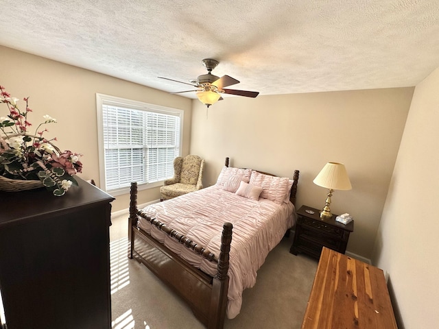 bedroom with ceiling fan, light colored carpet, and a textured ceiling