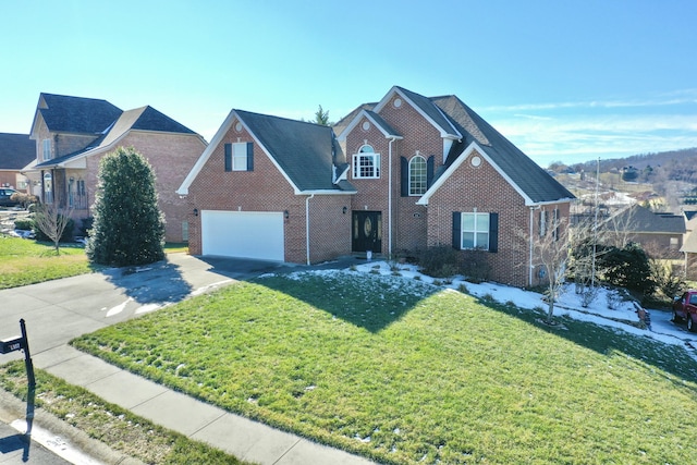 front facade with a front yard and a garage